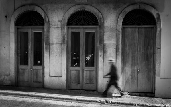 Black and white photo of three arched doorways.